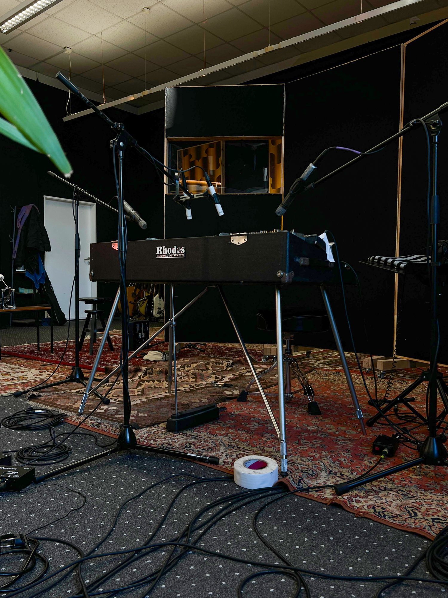 The piano mic'd up in the recording room